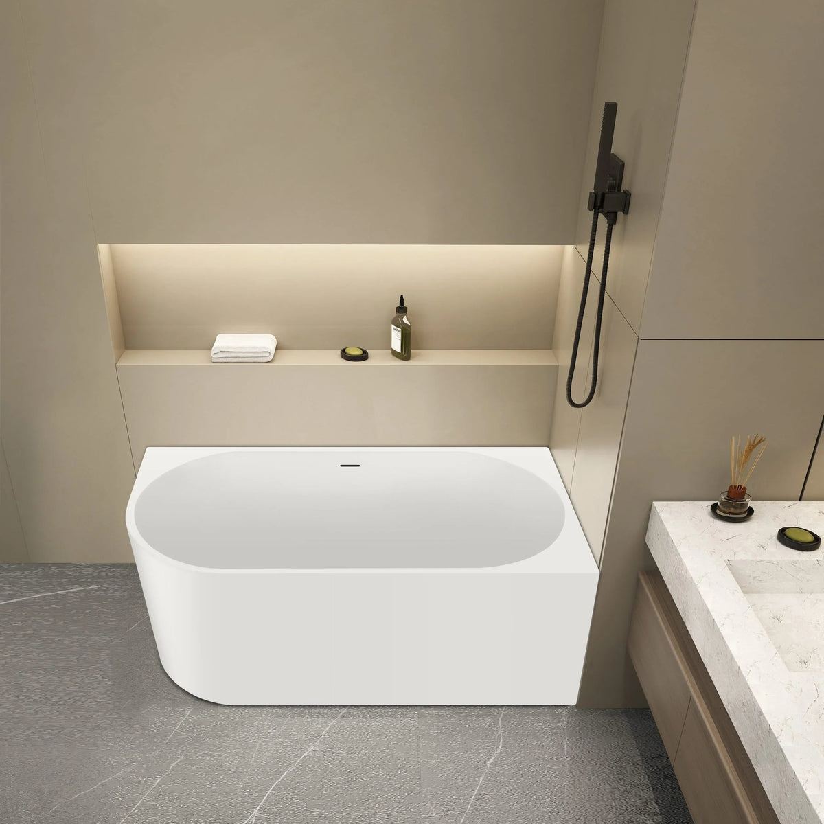 Modern bathroom with a white freestanding bathtub against a beige wall.