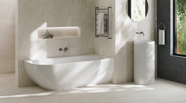 White corner bath in a contemporary tiled bathroom