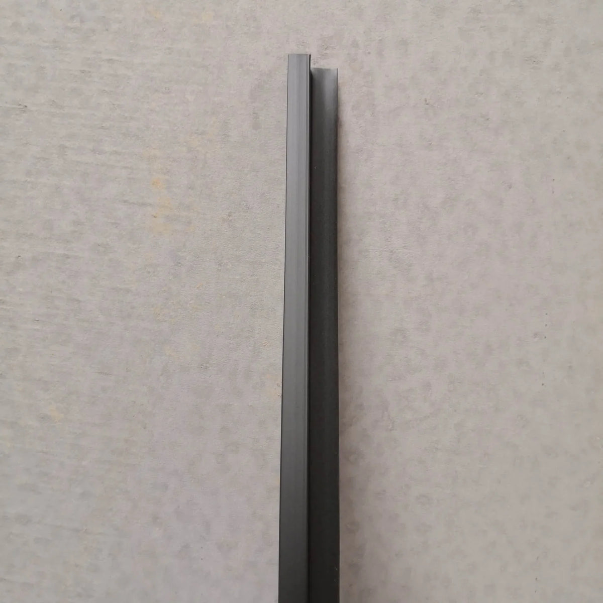 Lengthwise view of the black shower screen side seal strip
